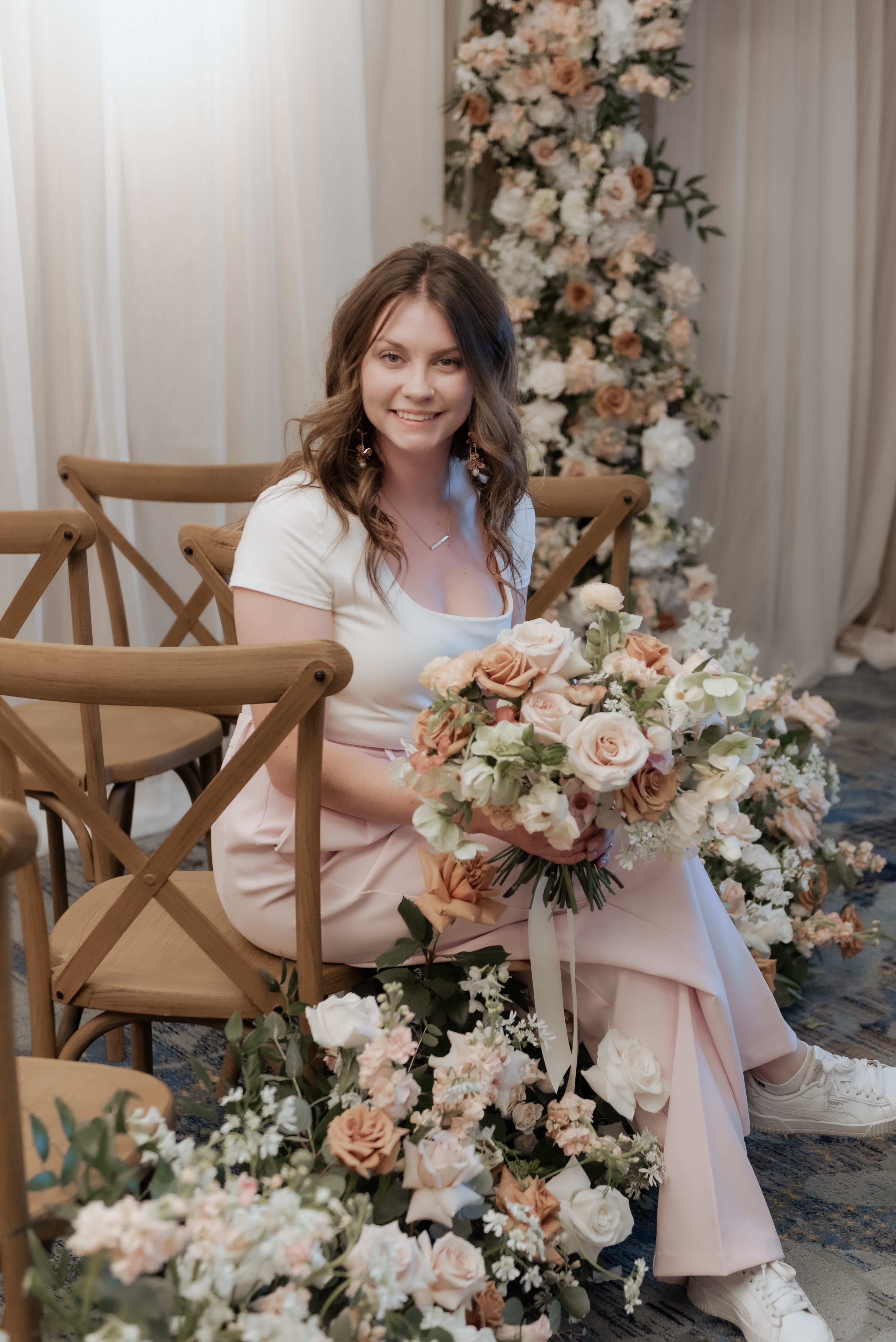 Woman sitting with a bouquet of flowers in a decorated room